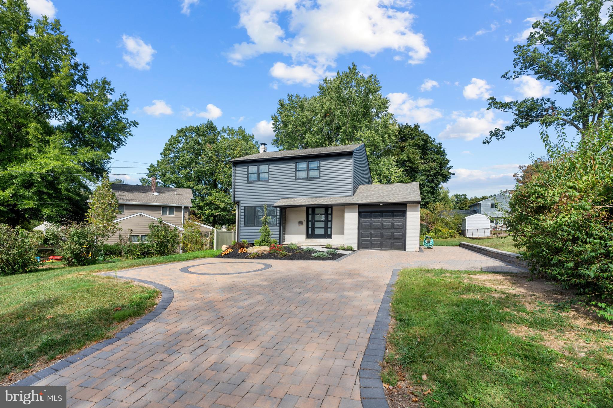 a front view of a house with a yard and a garage