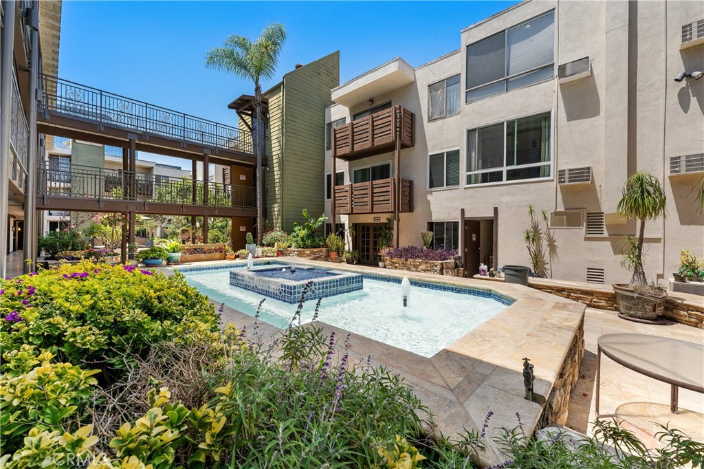 a view of a house with swimming pool and sitting area