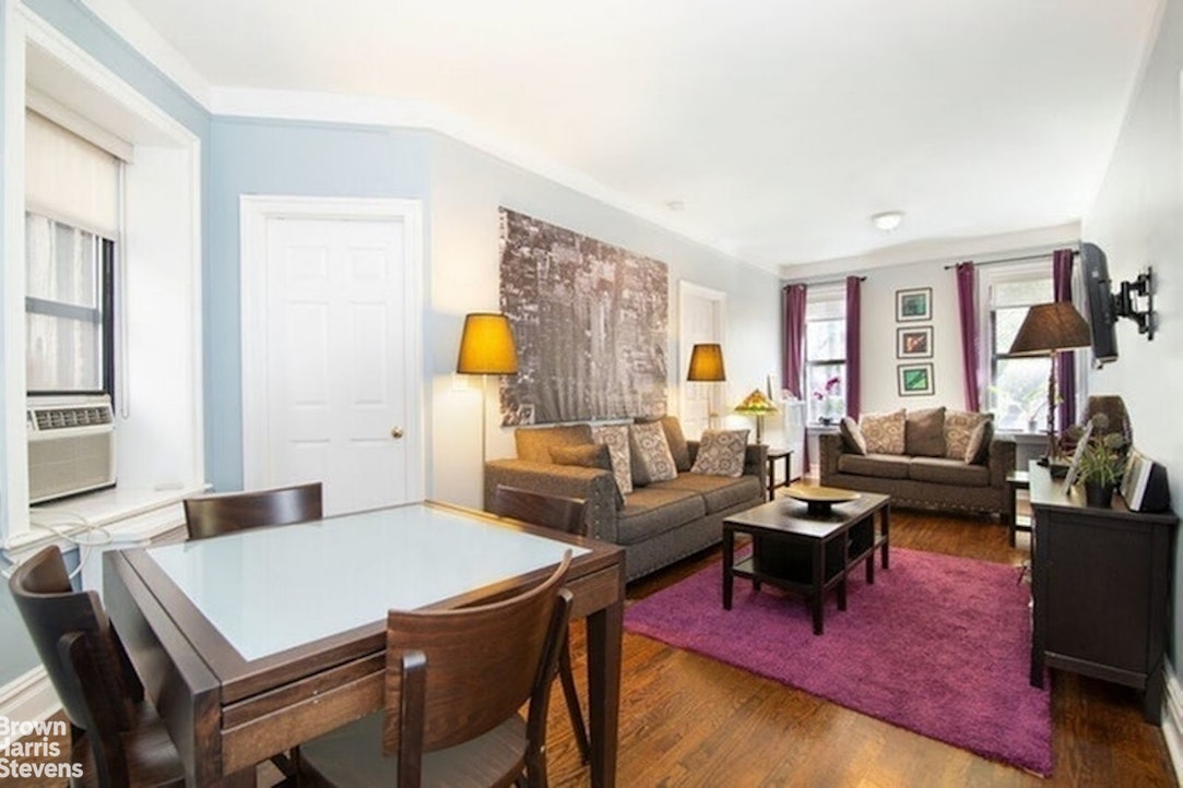 a living room with furniture rug and window