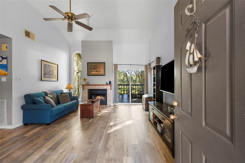 a living room with furniture a fireplace and a flat screen tv