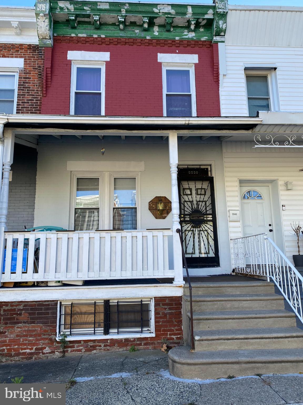 a front view of a house with stairs