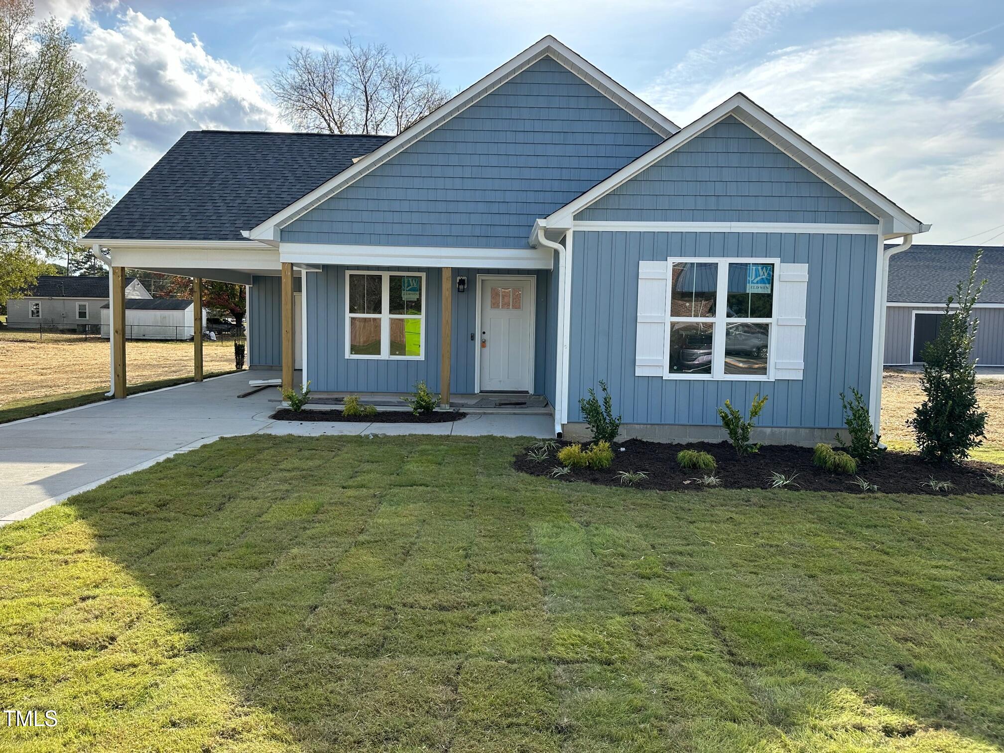 a front view of house with yard outdoor seating and barbeque oven