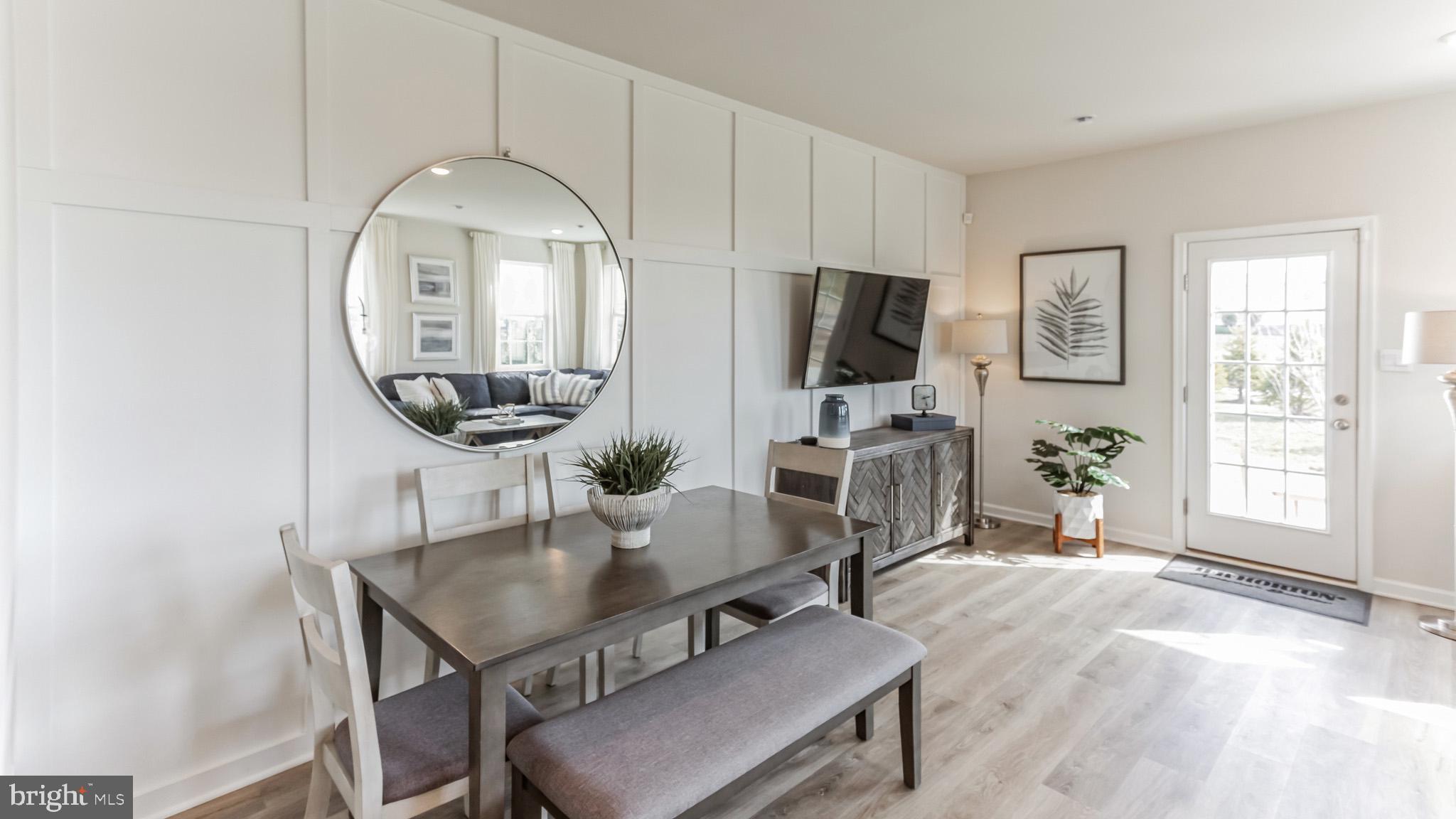 a living room with furniture a flat screen tv and a large window