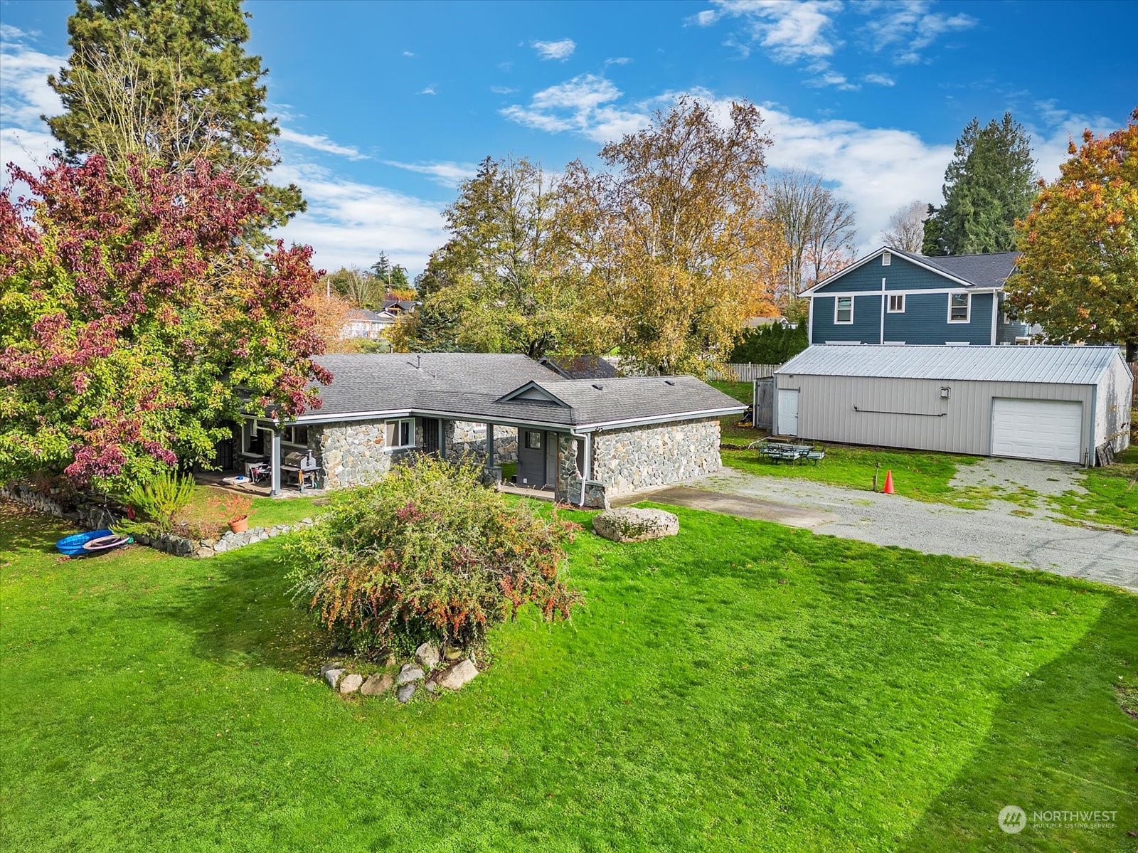 a front view of house with yard and trees in the background