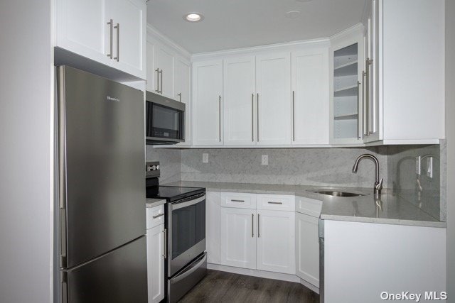 a kitchen with stainless steel appliances granite countertop a refrigerator and a sink