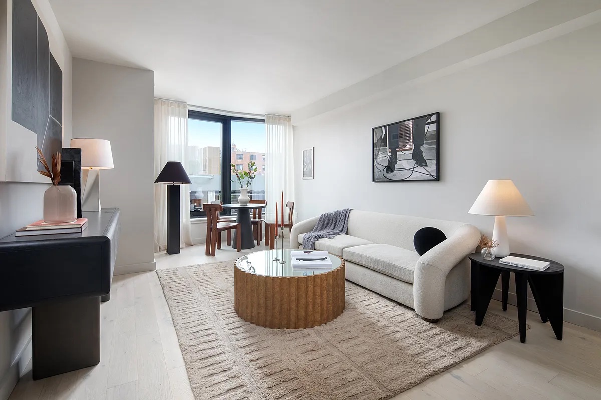 a living room with furniture and a lamp