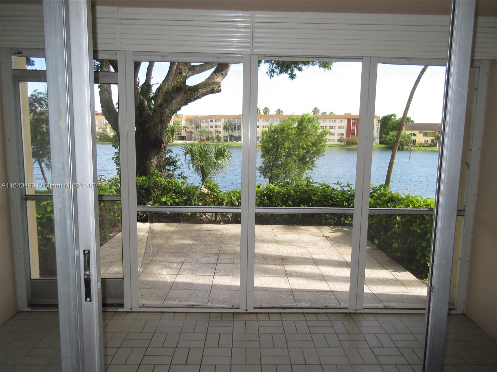 a view of a glass door with a yard