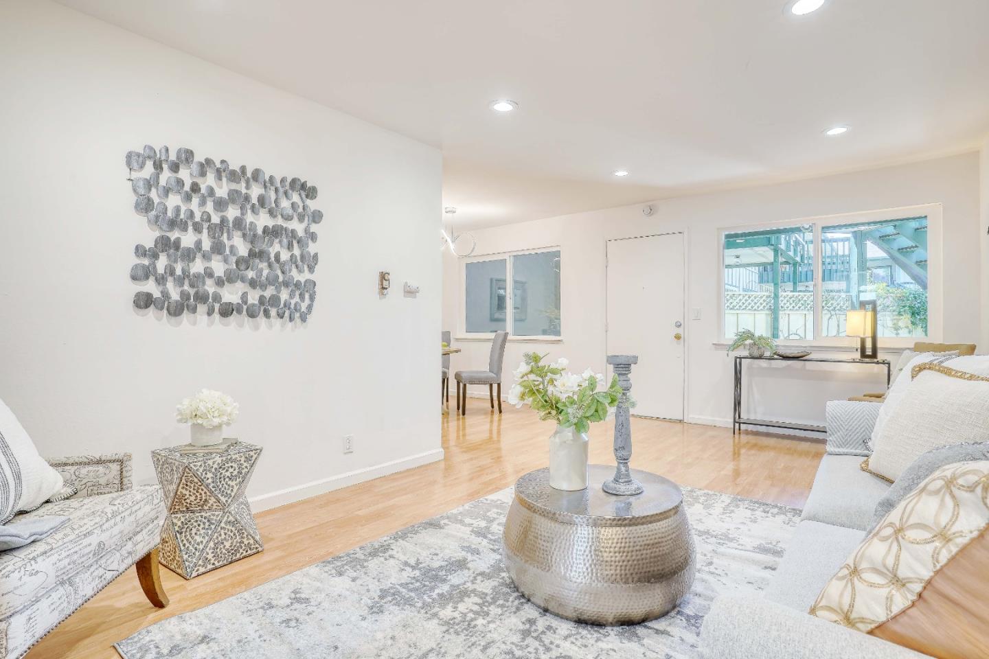 a living room with furniture and a potted plant