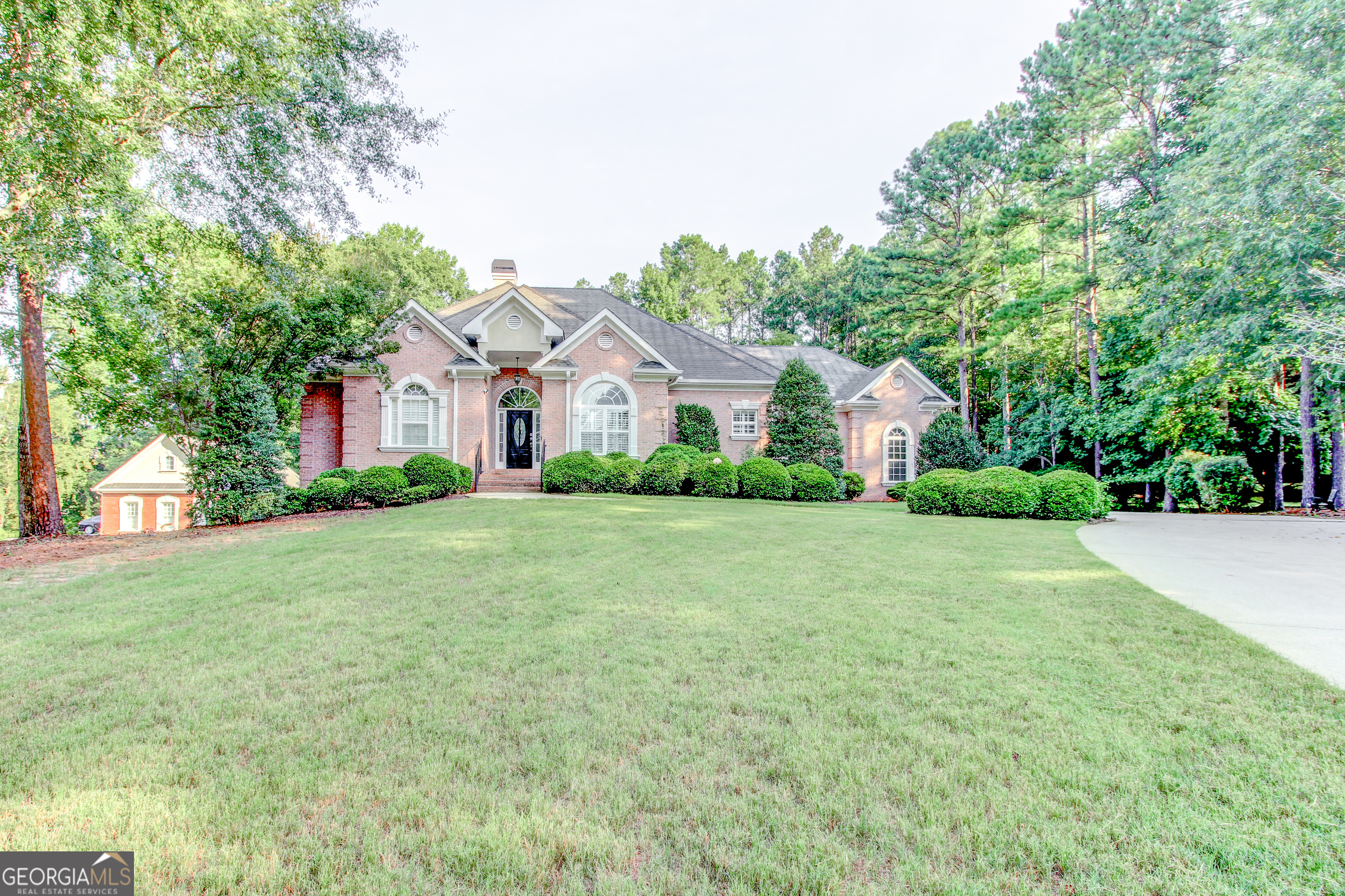 a front view of house with yard and green space