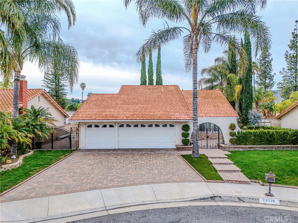 a front view of a house with a yard and palm tree