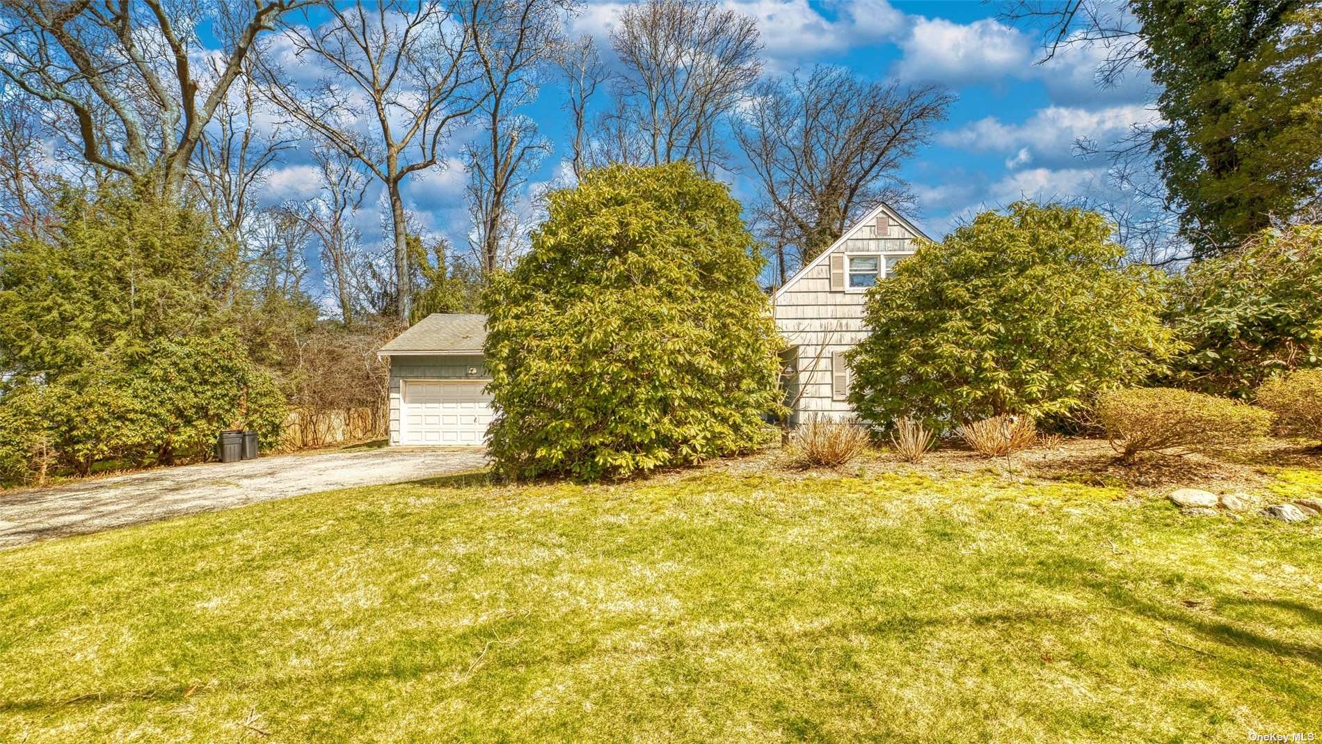 a tall yellow house with a yard in front of it