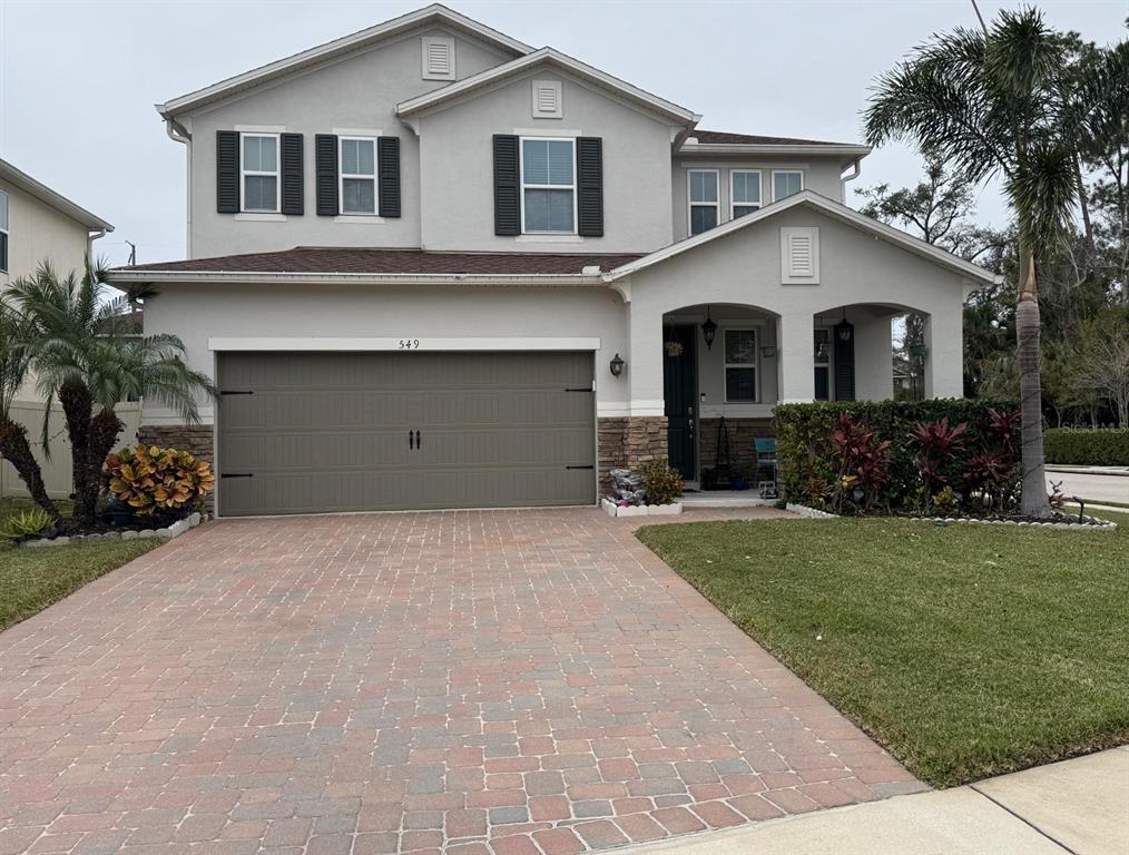 a front view of a house with a yard and garage