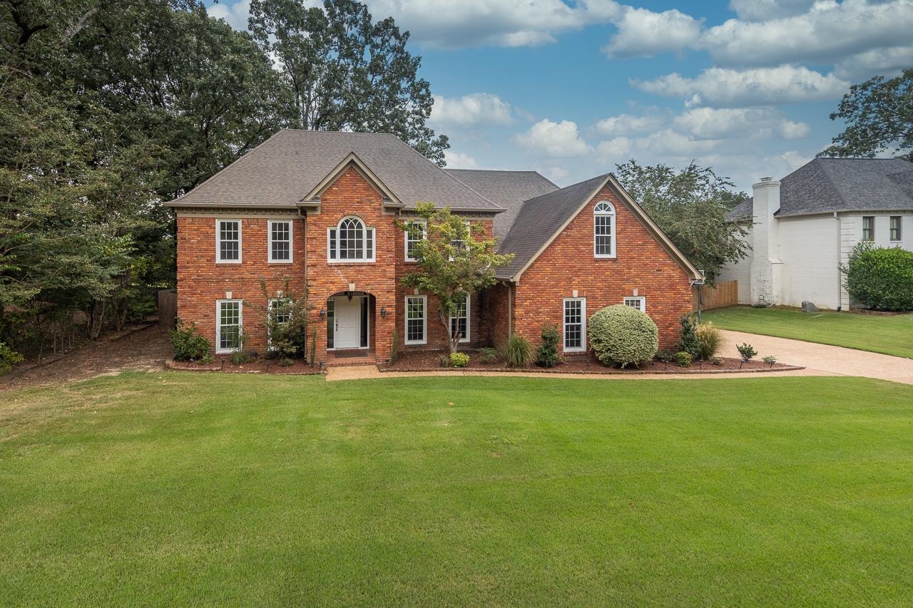 a front view of a house with a yard and garage