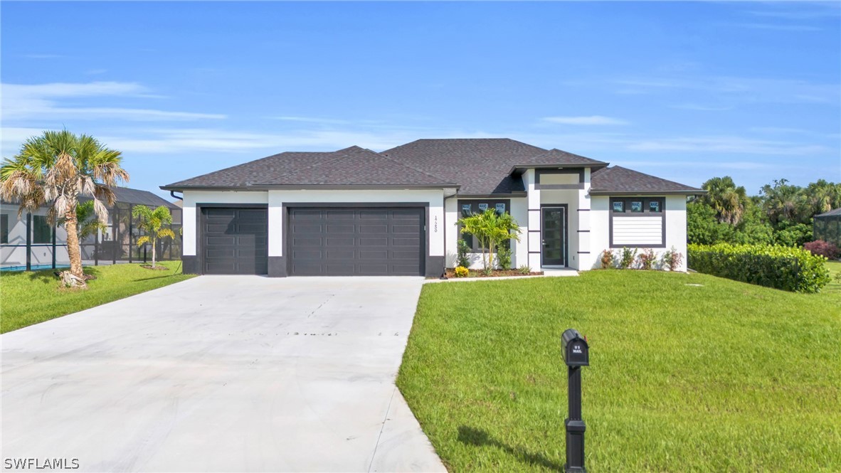 a front view of a house with a yard and garage