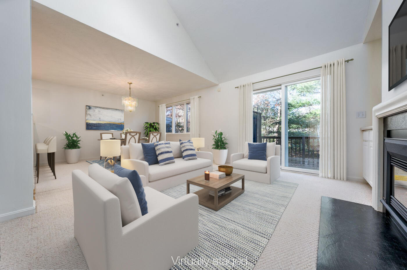 a living room with furniture large windows and a fireplace