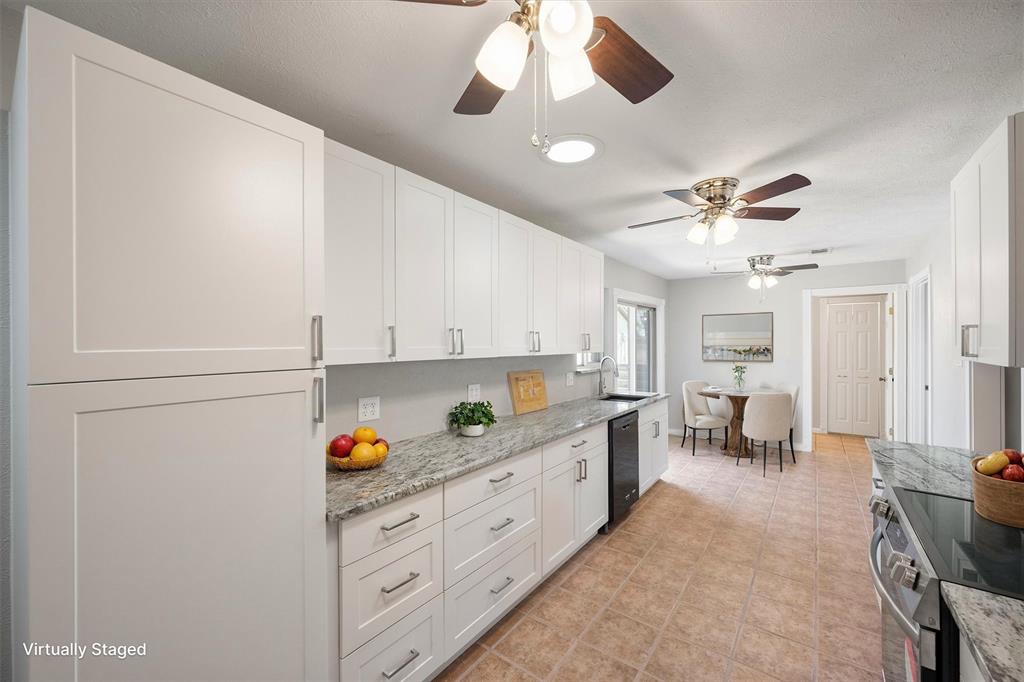 a kitchen with stainless steel appliances kitchen island granite countertop a sink and cabinets