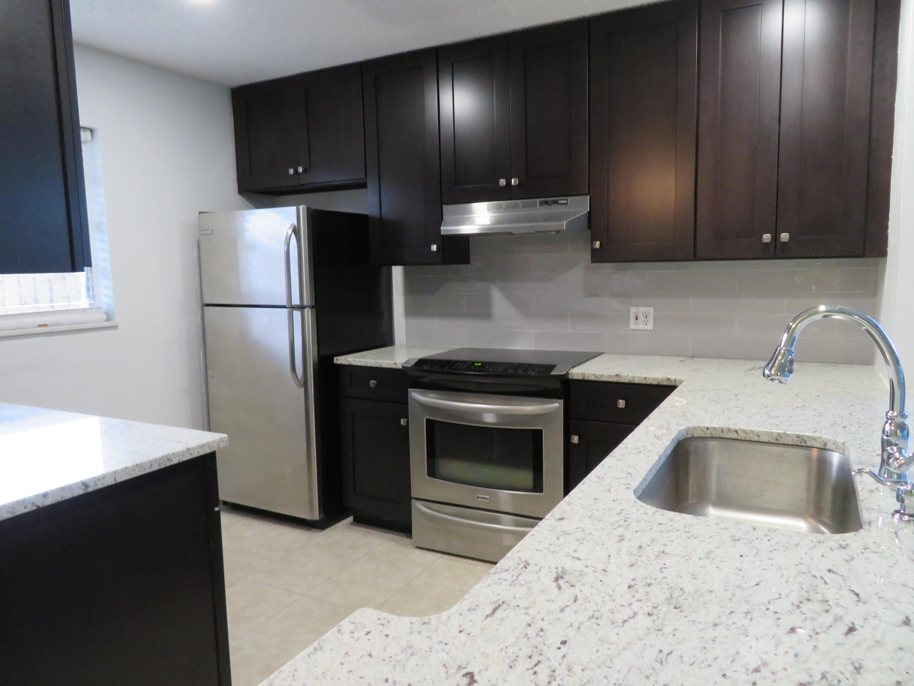 a kitchen with a sink a stove and refrigerator