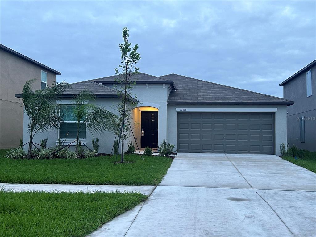 a front view of a house with a yard and garage