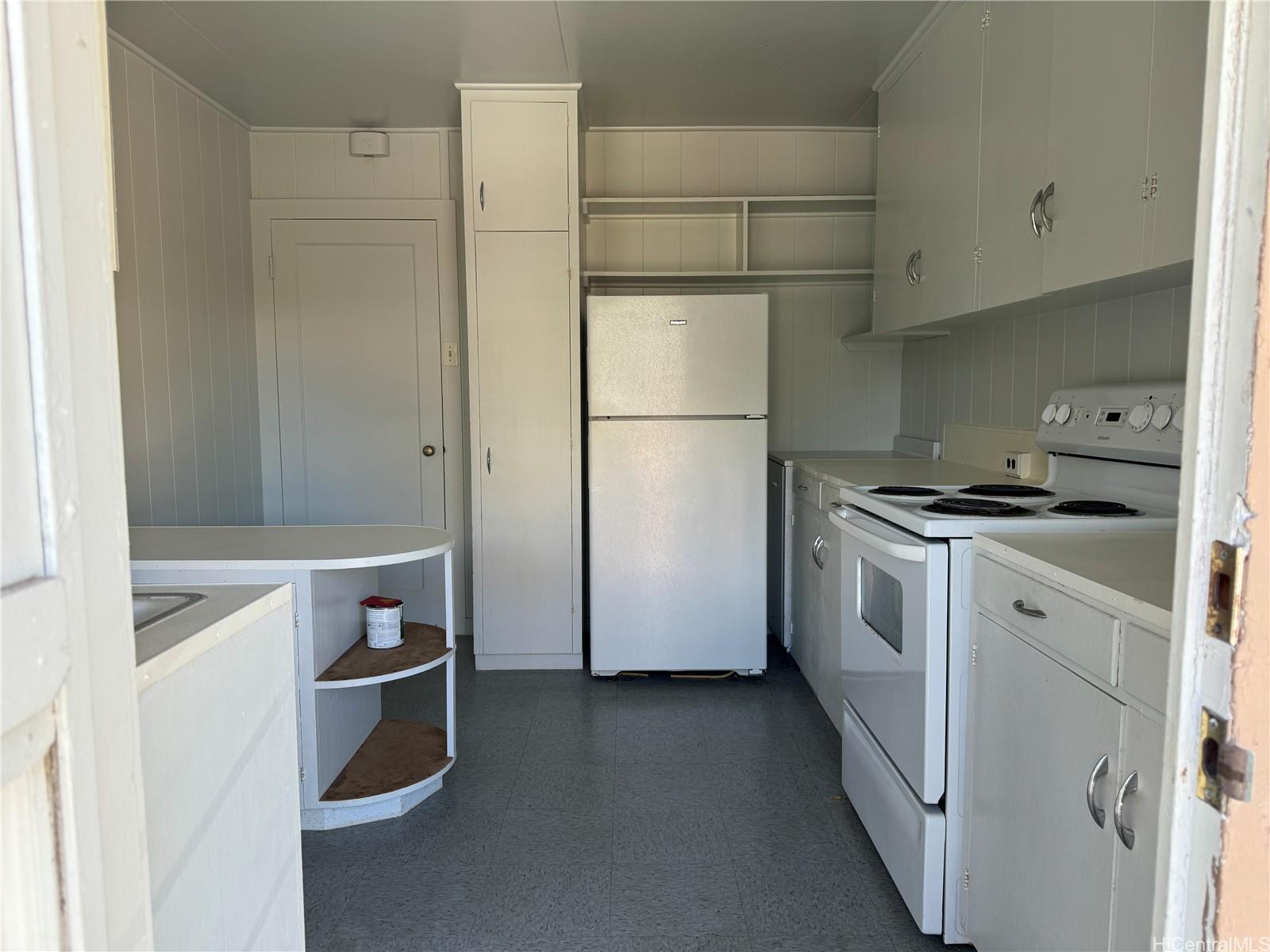 a kitchen with a refrigerator sink stove and cabinets