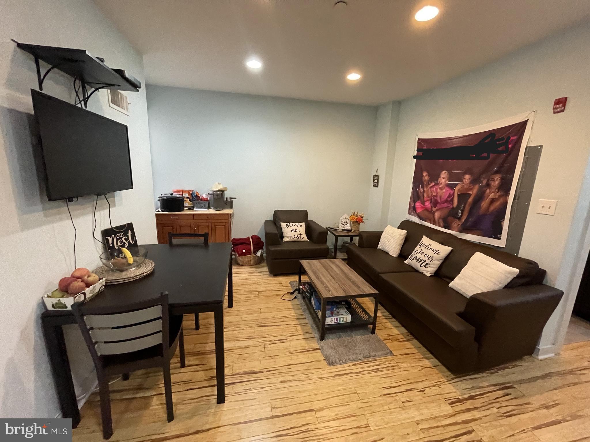 a living room with furniture and a flat screen tv