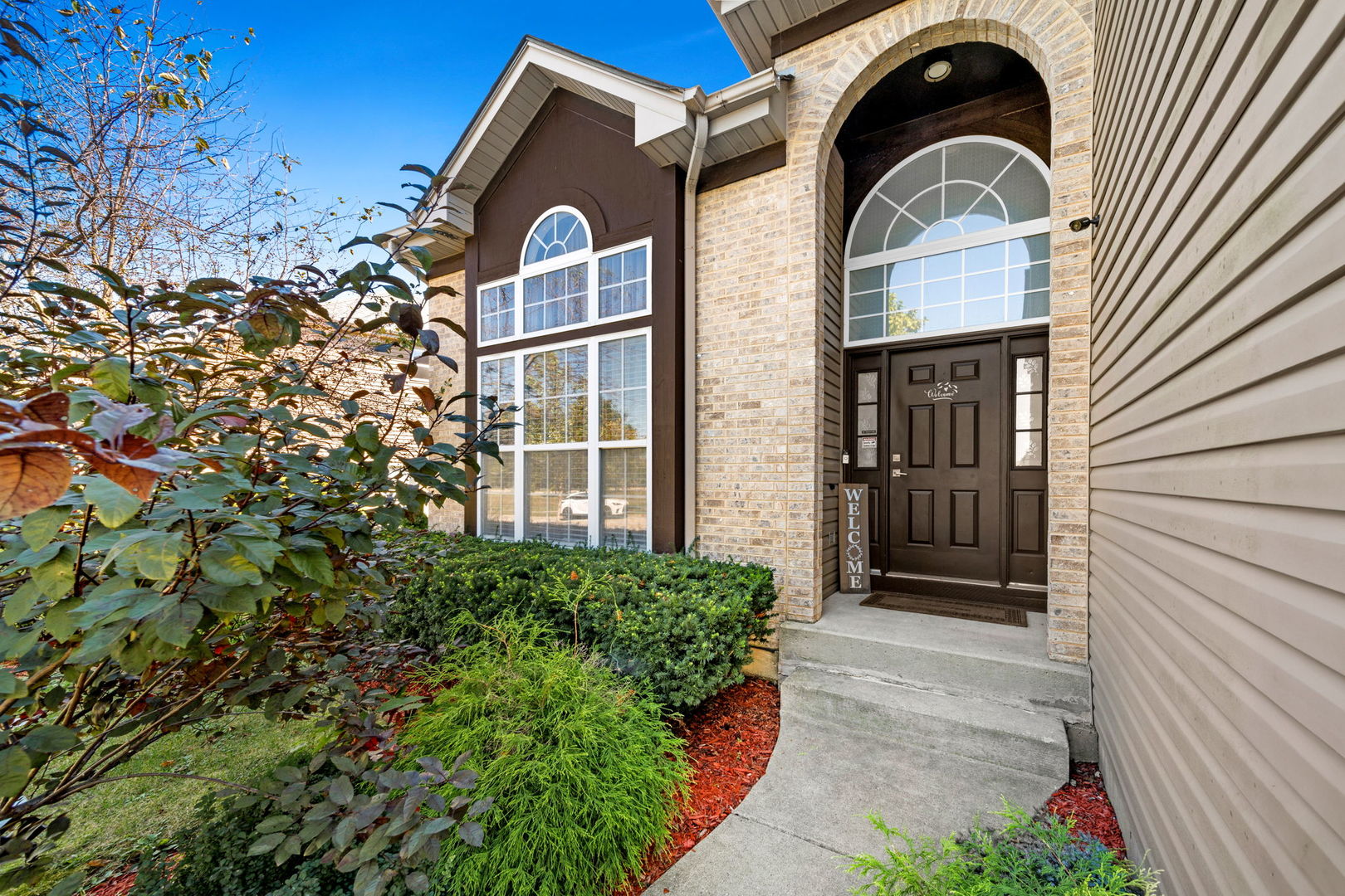 a front view of a house with a yard