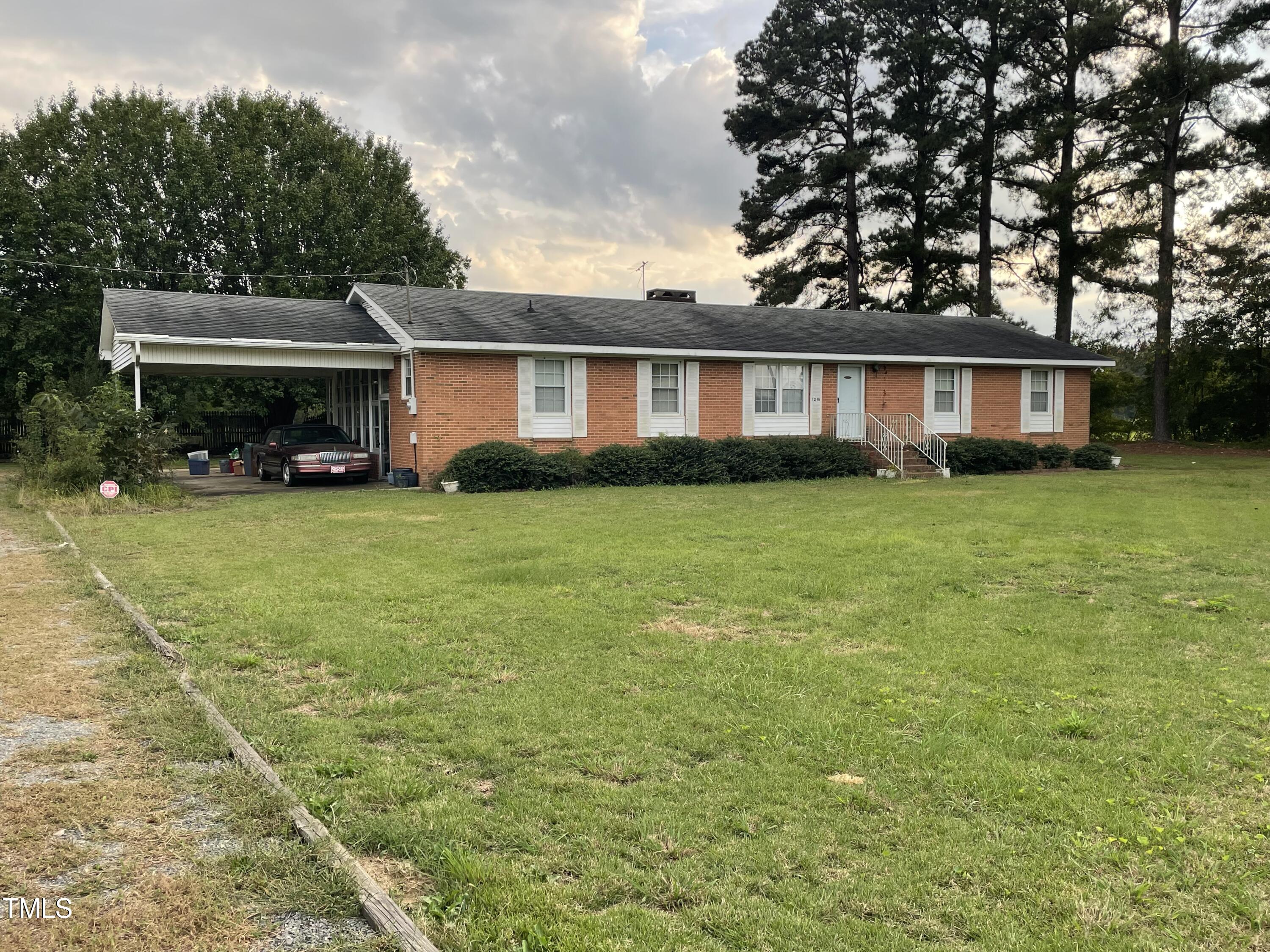 a view of a house with a yard and trees