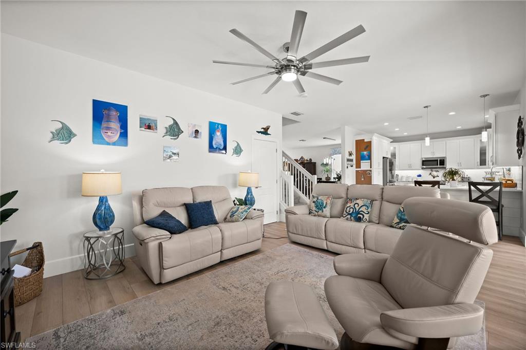 a living room with furniture and a view of kitchen