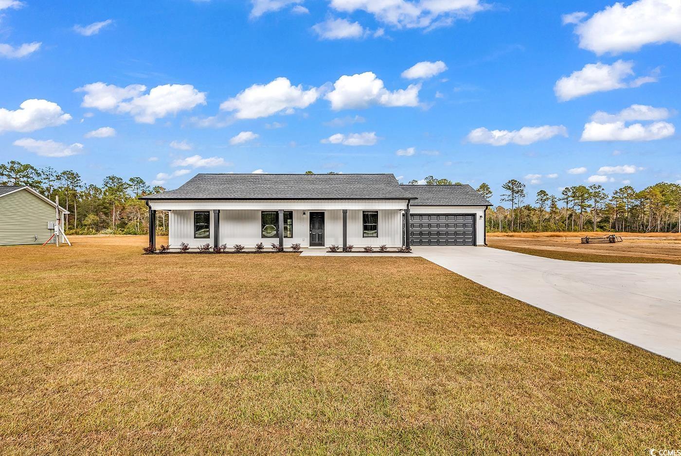 View of front of home featuring a front yard, cove