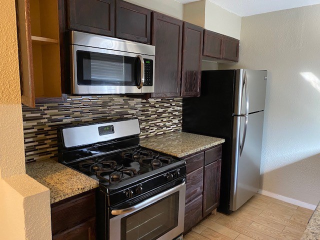 a kitchen with a stove microwave and refrigerator