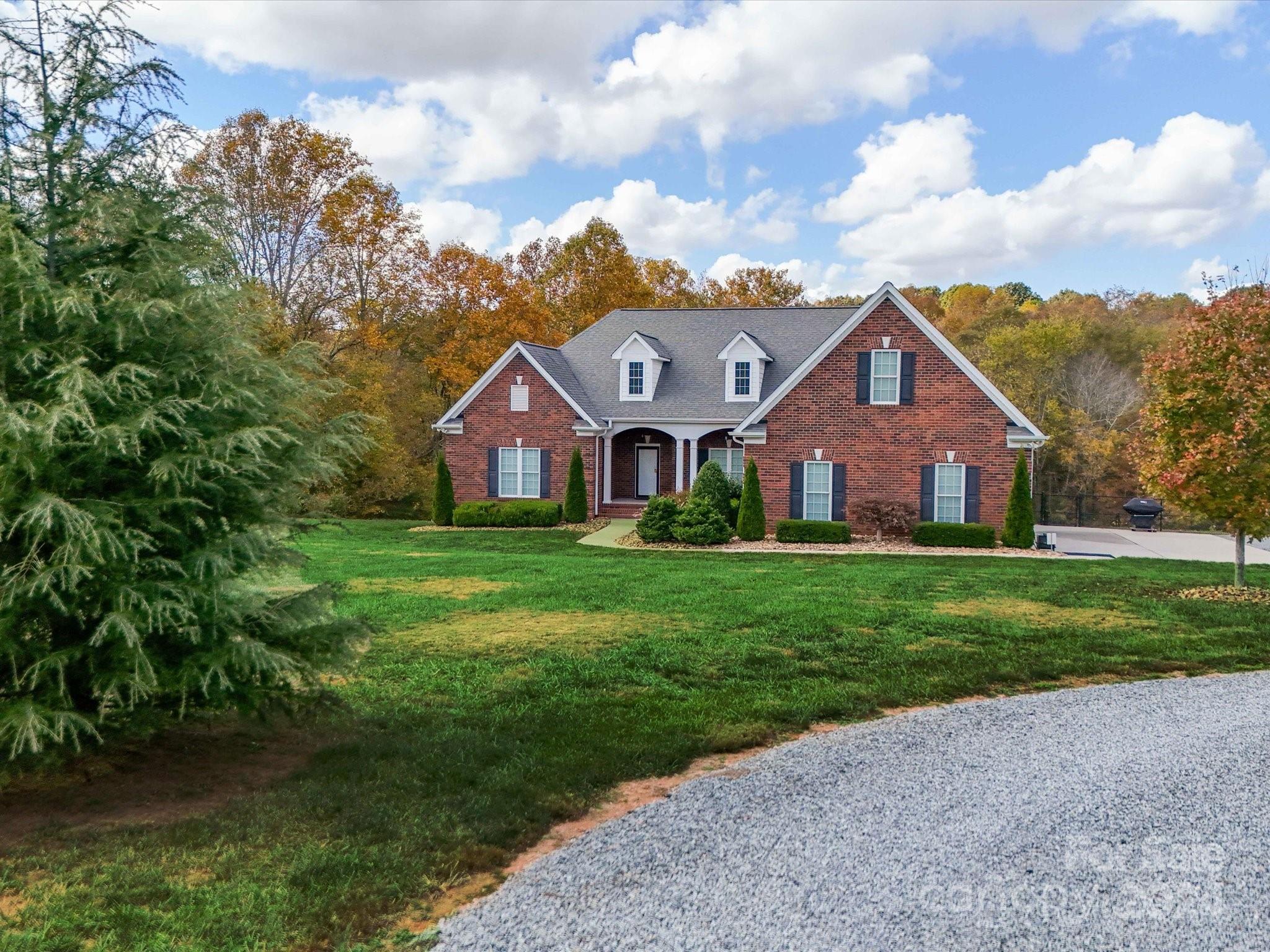 a front view of house with yard and green space