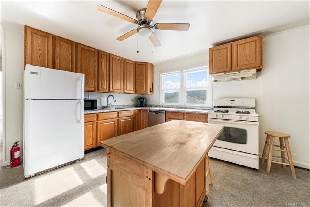 a kitchen with a stove a refrigerator and a sink