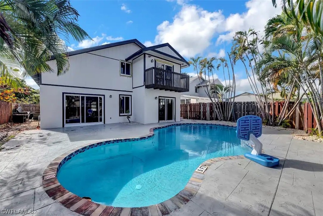 a view of a house with swimming pool in front of it