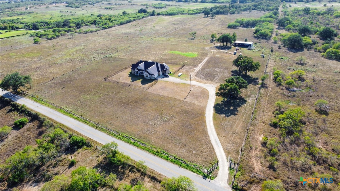 an aerial view of a house with a yard and lake view