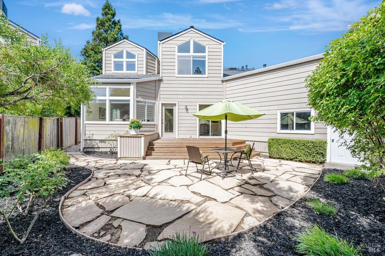 a view of a house with backyard and sitting area