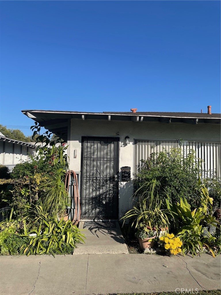 a view of a potted plants in front of a house