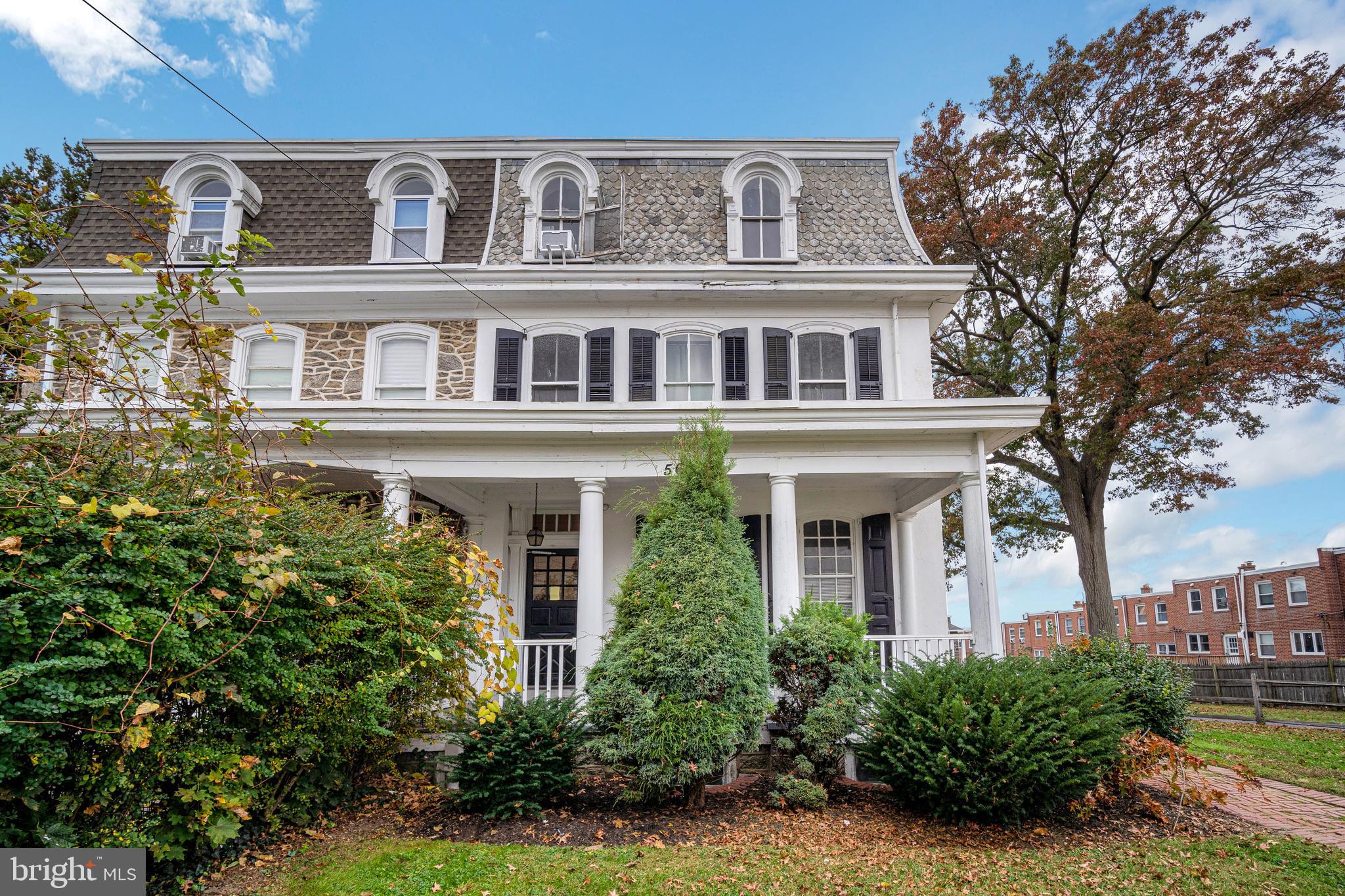 a front view of a house with a yard garage and outdoor seating