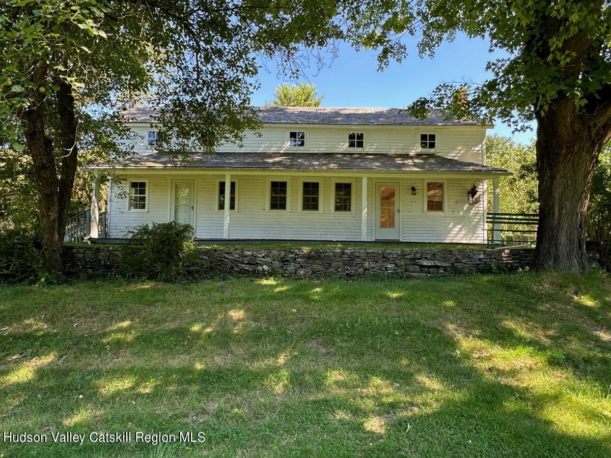 a front view of house with yard and green space