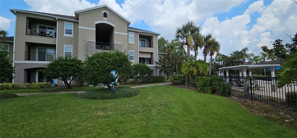 a front view of house with yard and green space