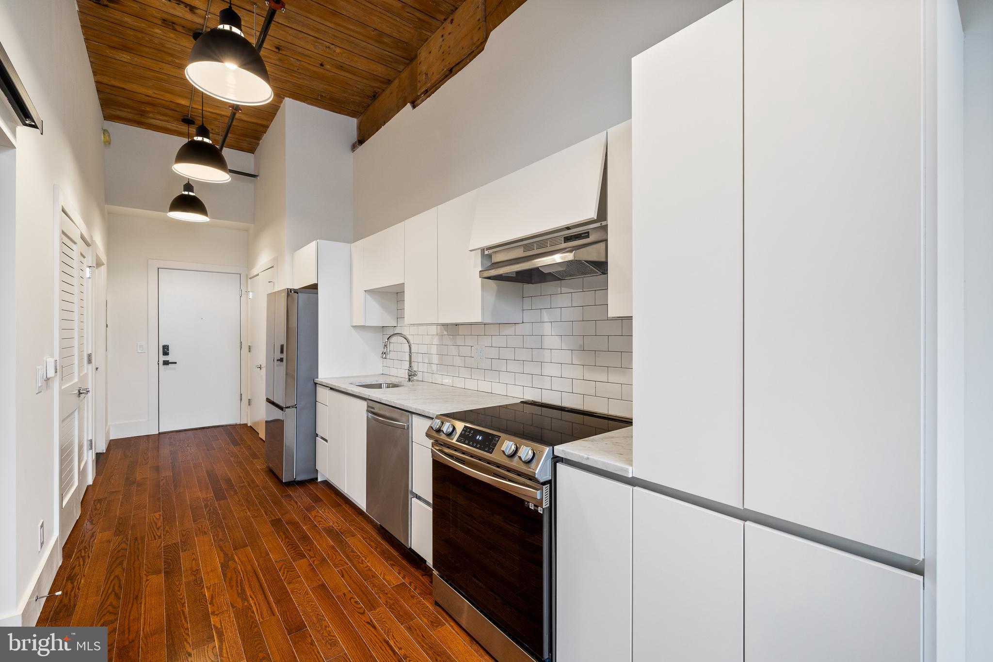 a kitchen with stainless steel appliances granite countertop a stove and a refrigerator