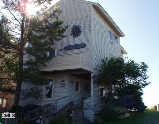 a front view of a house with plants