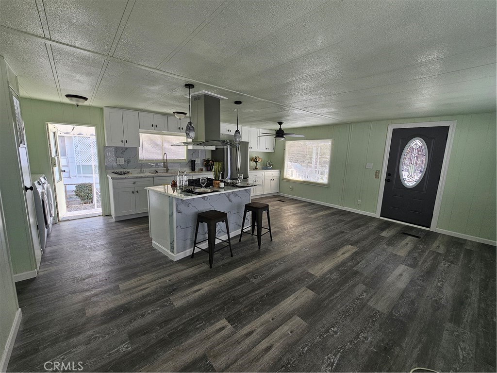 a view of a kitchen and dining room with wooden floor