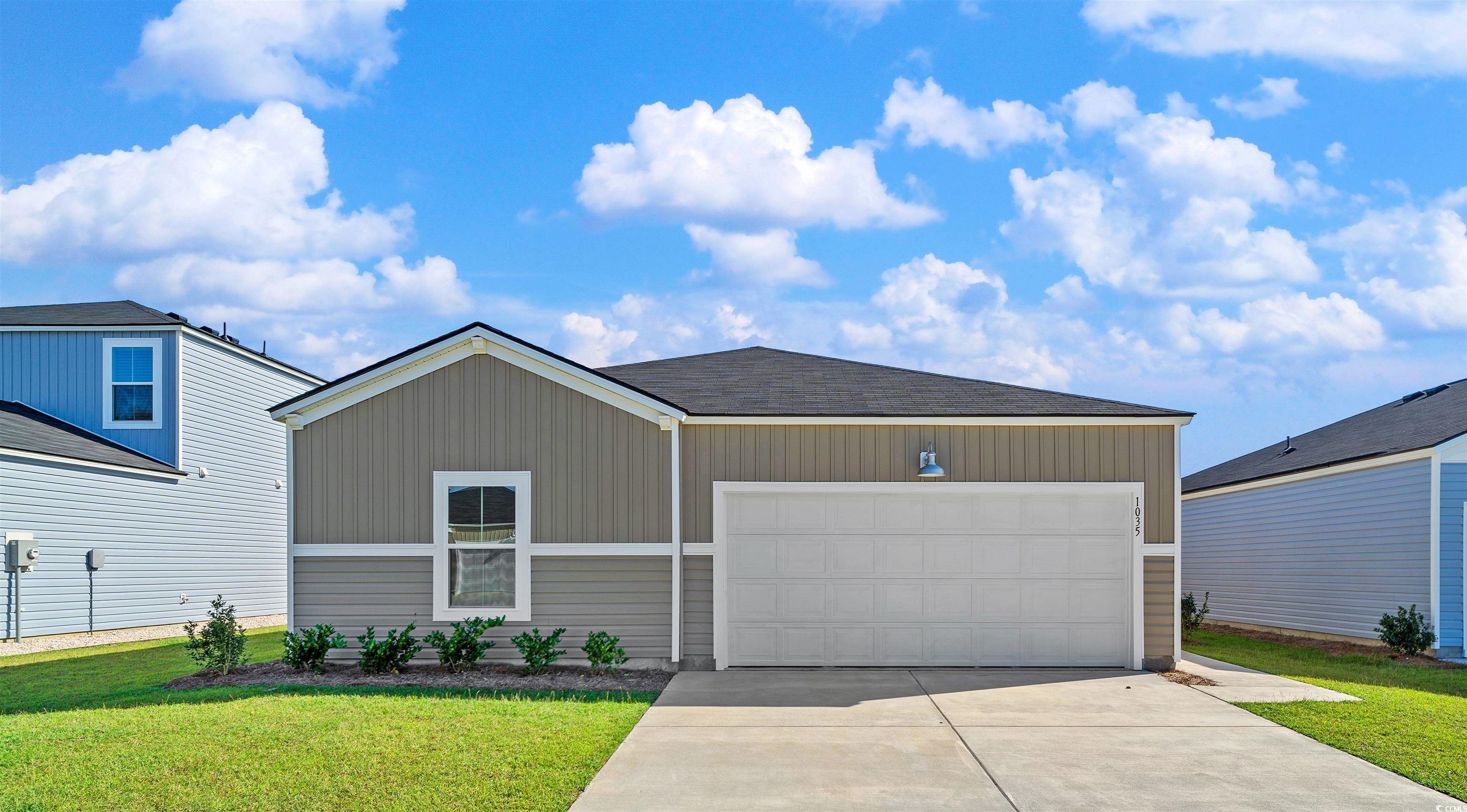 View of front of property with a garage and a fron