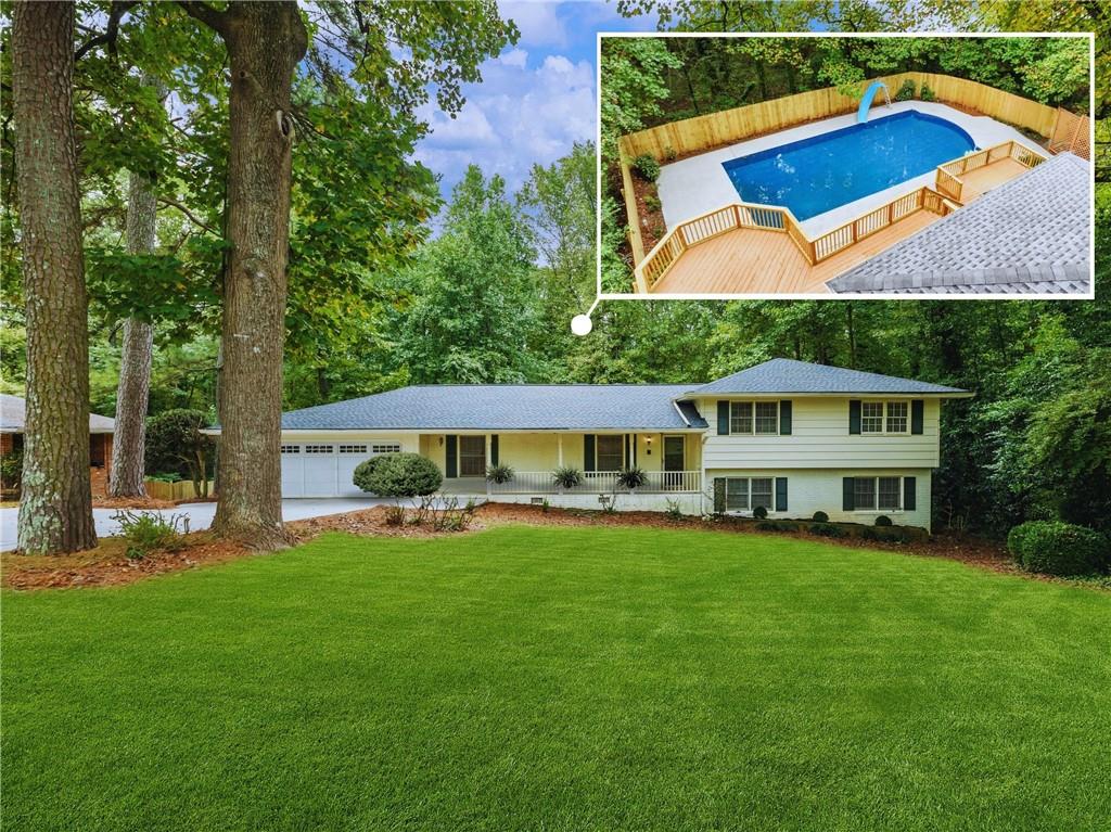 a view of a house with a yard and sitting area