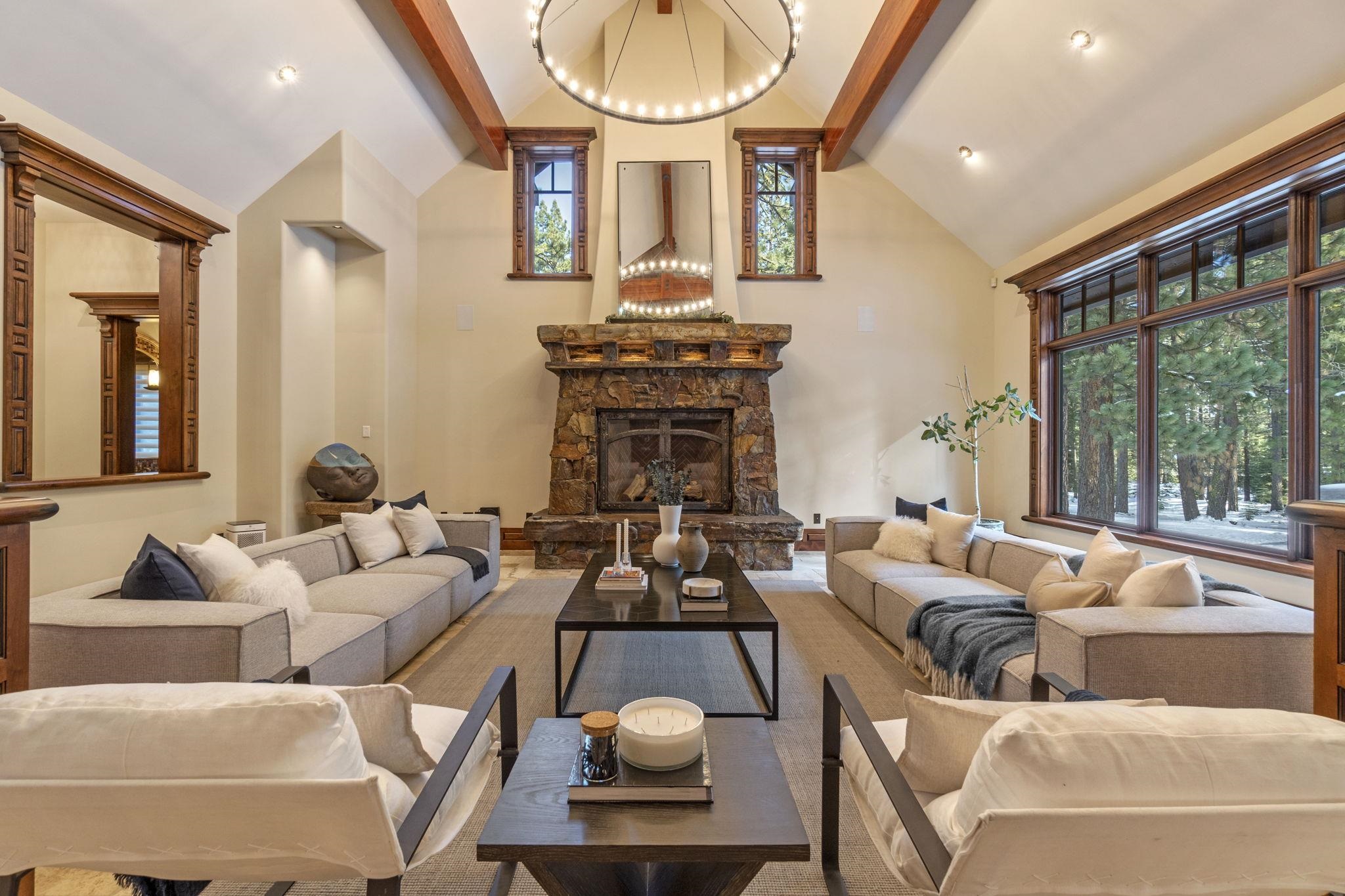 a living room with furniture a fireplace and a large window