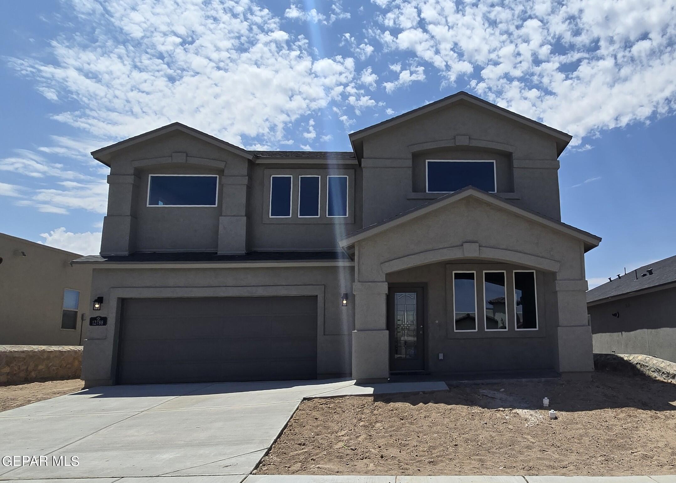 a front view of a house with garage