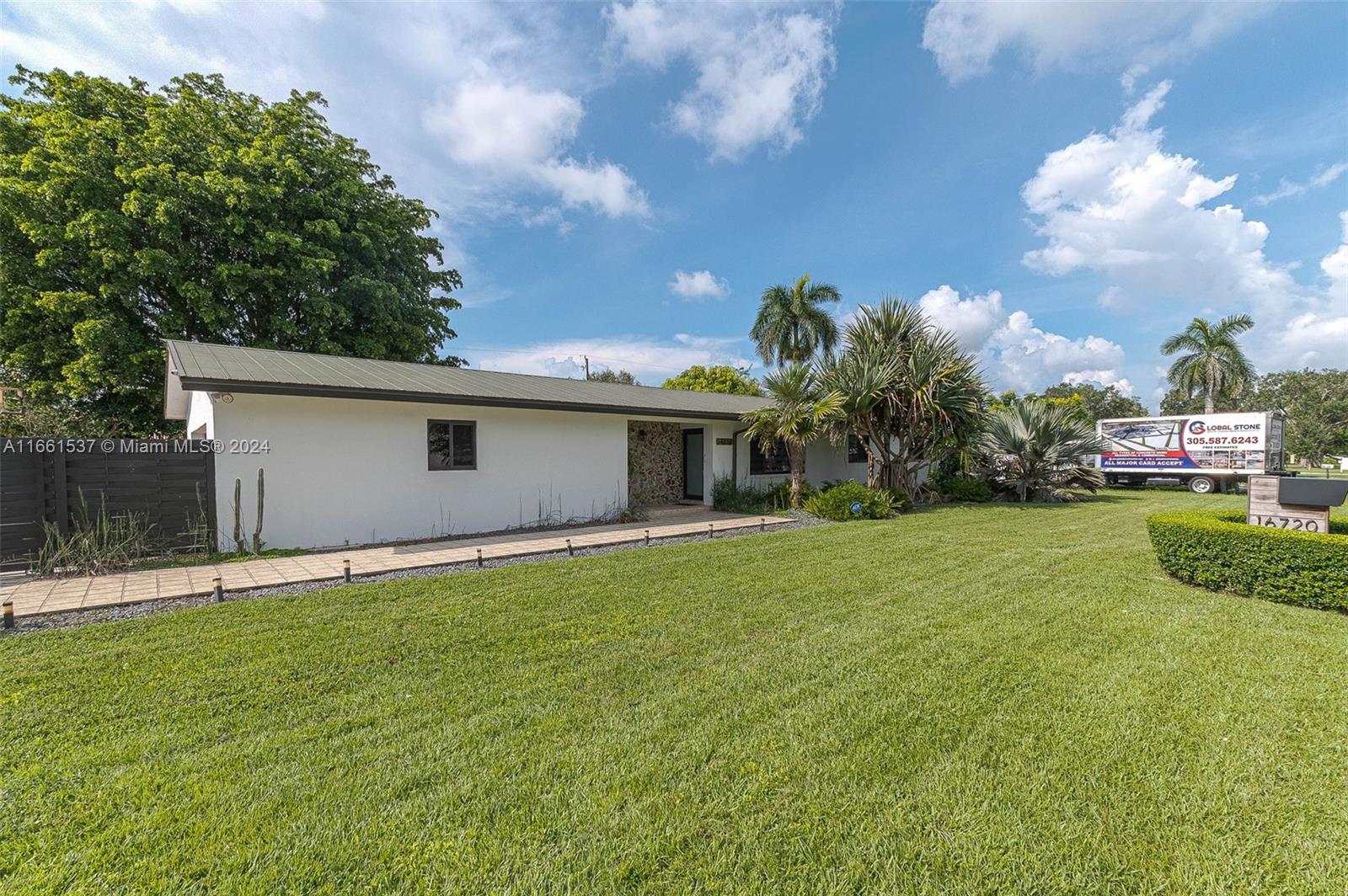 a front view of house with yard and green space