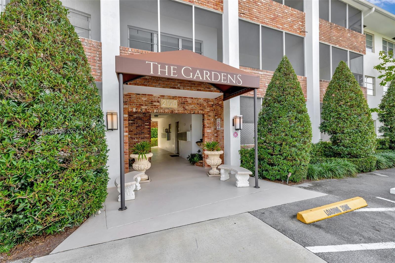 front view of a building with potted plants