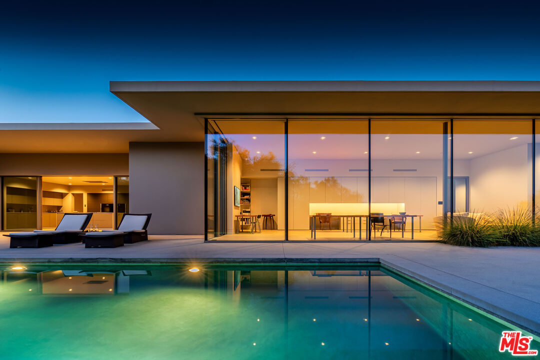 a swimming pool table and chairs in patio