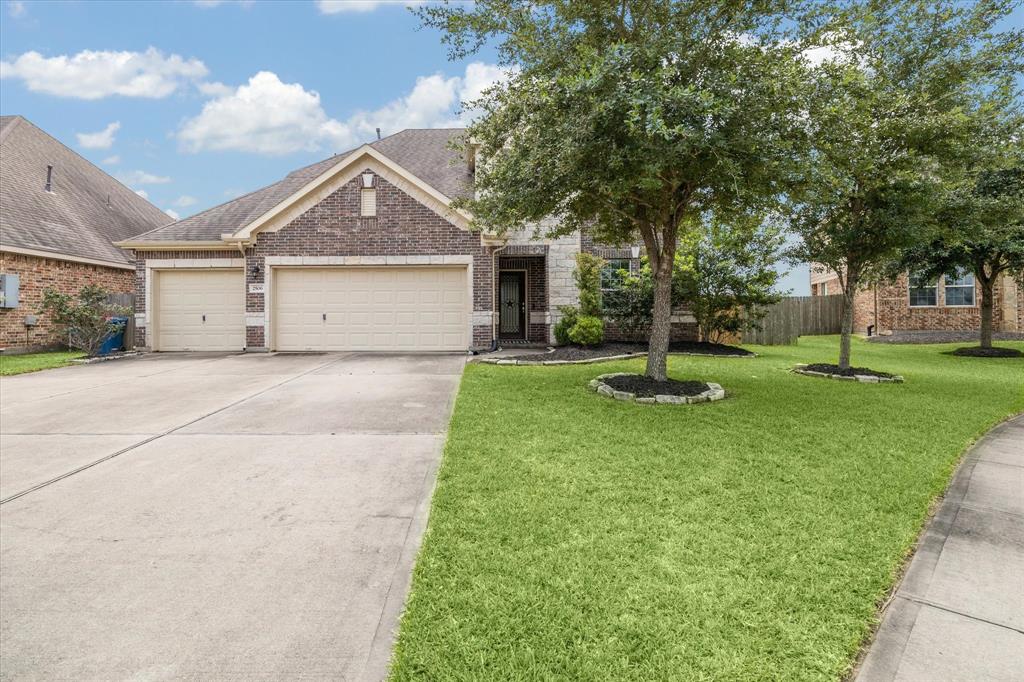 a view of a house with a yard and tree