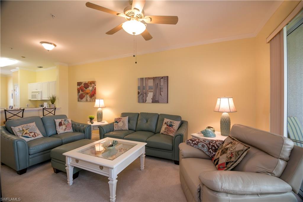 a living room with furniture a couch and a chandelier